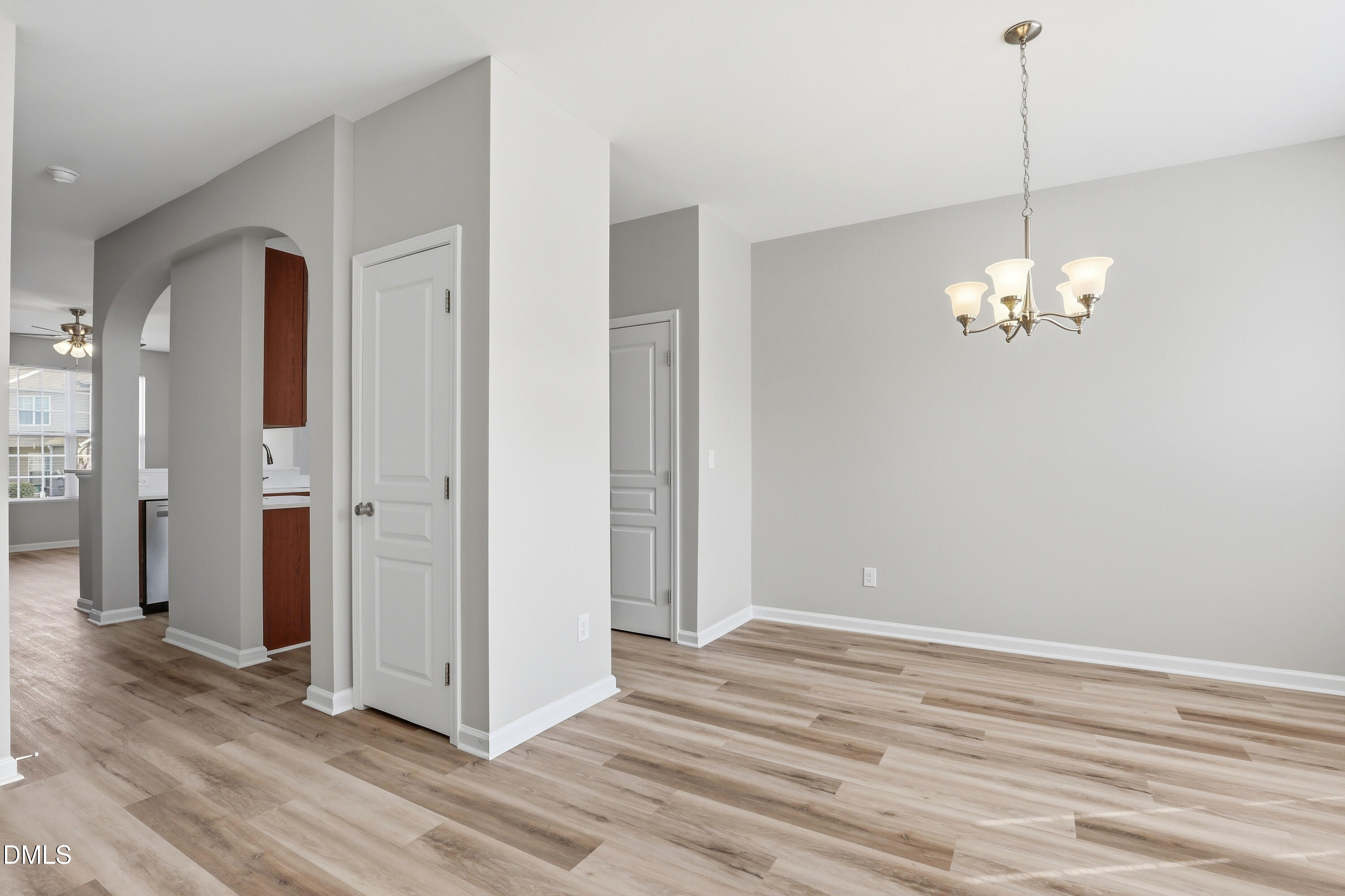 715 Bryant Street Raleigh, NC 27603 - Photo 4 of 25 a view of a chandelier in big room with wooden floor