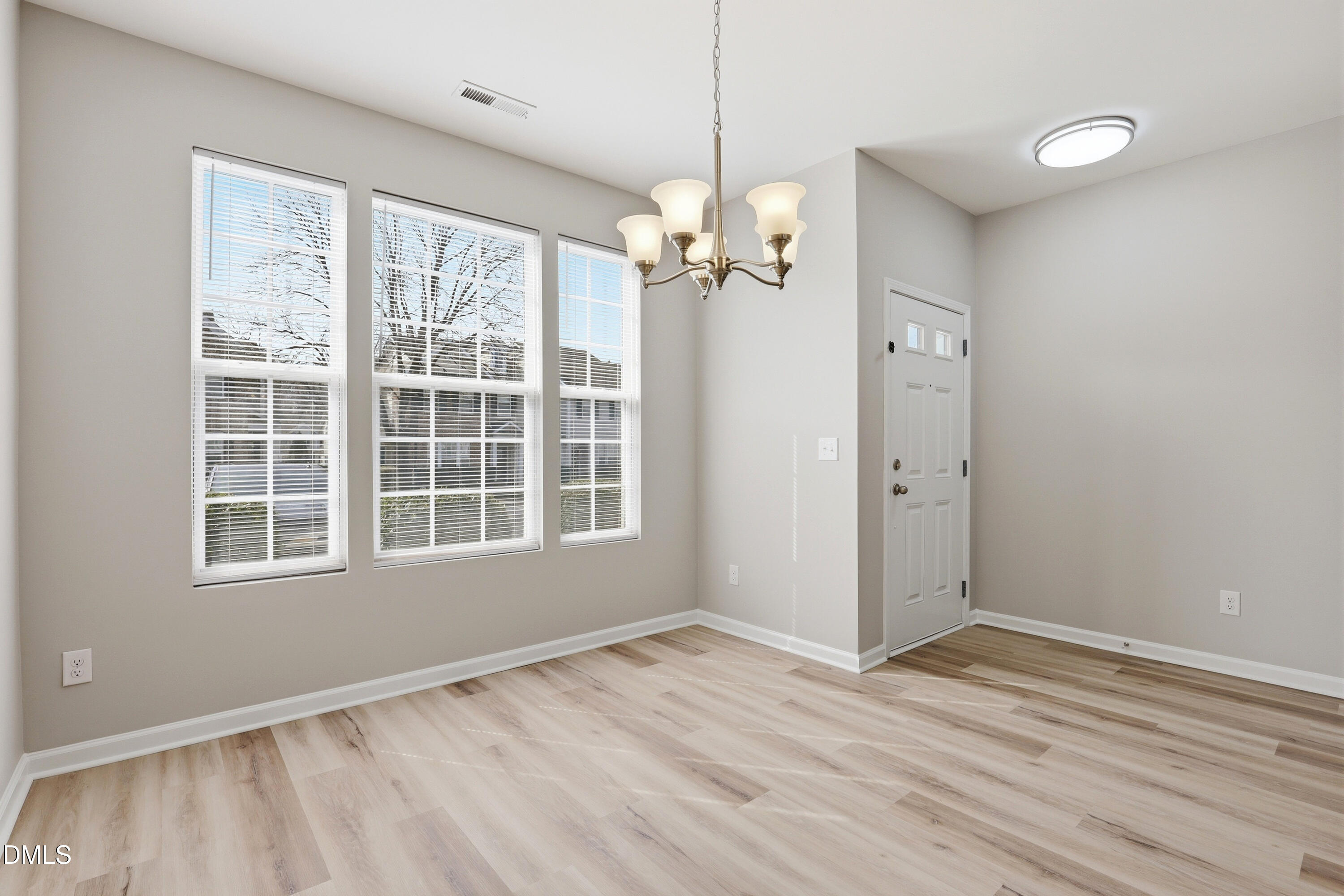 715 Bryant Street Raleigh, NC 27603 - Photo 7 of 25 a view of an empty room with a window and wooden floor