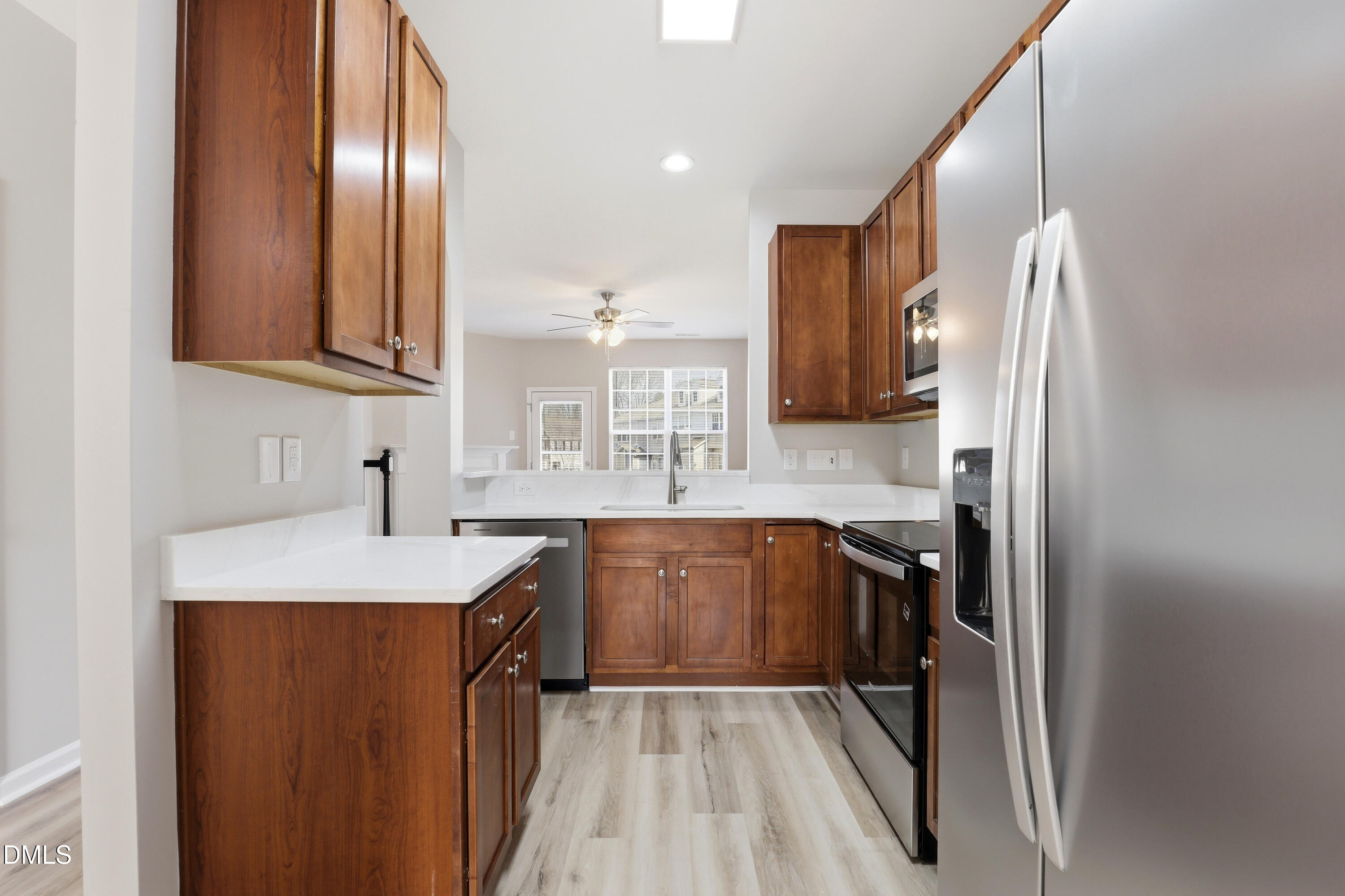715 Bryant Street Raleigh, NC 27603 - Photo 8 of 25 a kitchen with stainless steel appliances granite countertop a sink stove and refrigerator