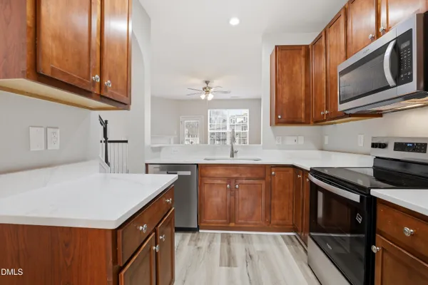 a kitchen with stainless steel appliances granite countertop a sink stove and microwave