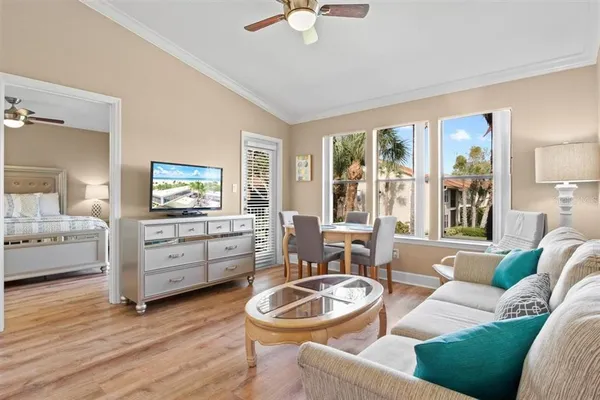a living room with furniture and a wooden floor