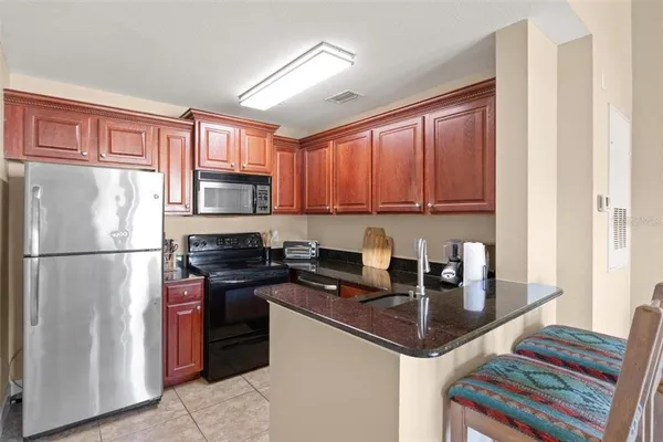 a kitchen with a refrigerator sink and cabinets
