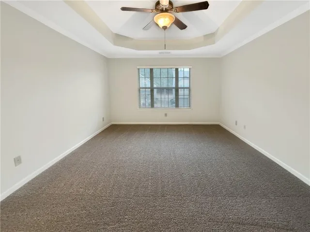 a view of room with a ceiling fan and window