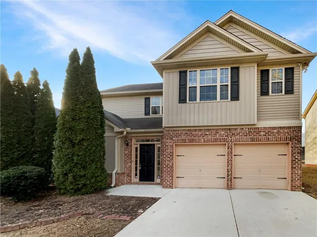 a front view of a house with a yard