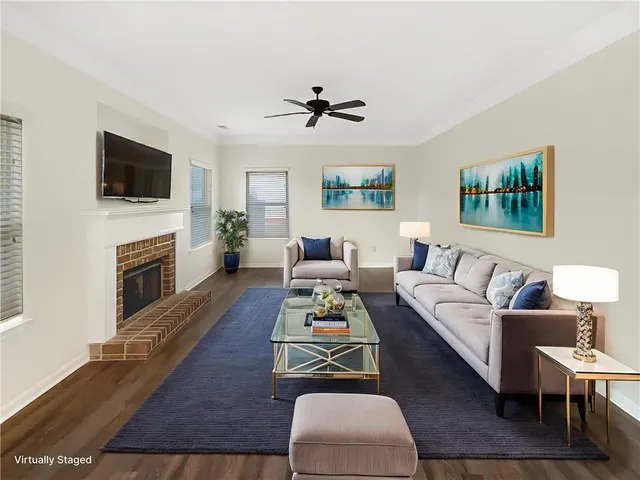 a living room with furniture fireplace and flat screen tv
