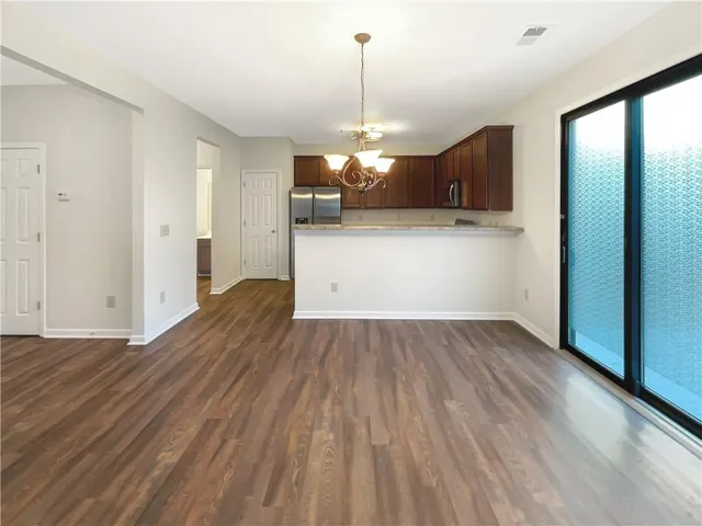 a view of a kitchen with wooden floor and a sink