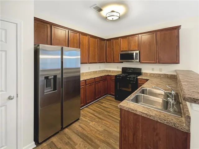 a kitchen with a refrigerator sink and microwave