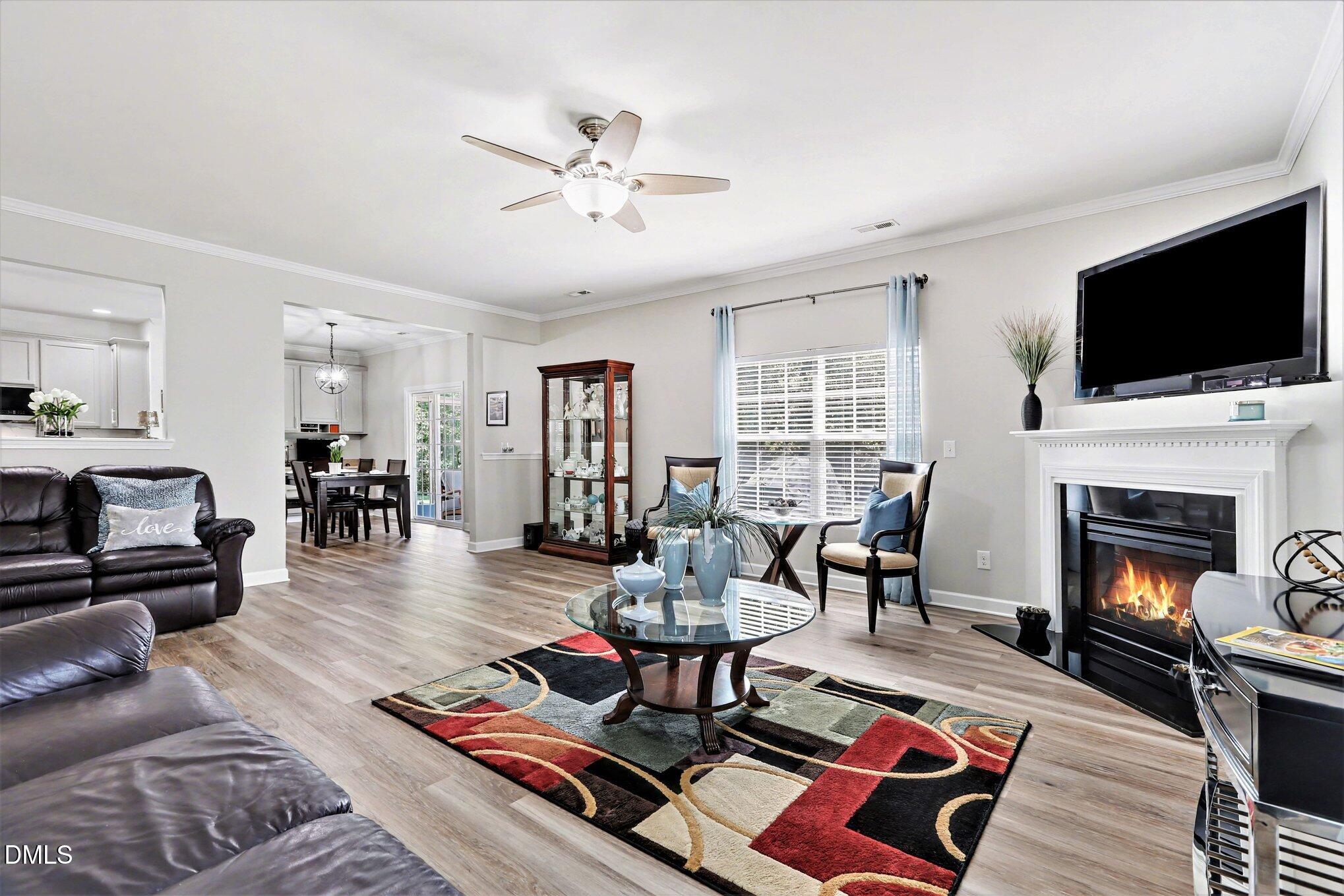 437 Field Glow Lane Apex, NC 27539 - Photo 11 of 48 a living room with furniture fireplace and flat screen tv