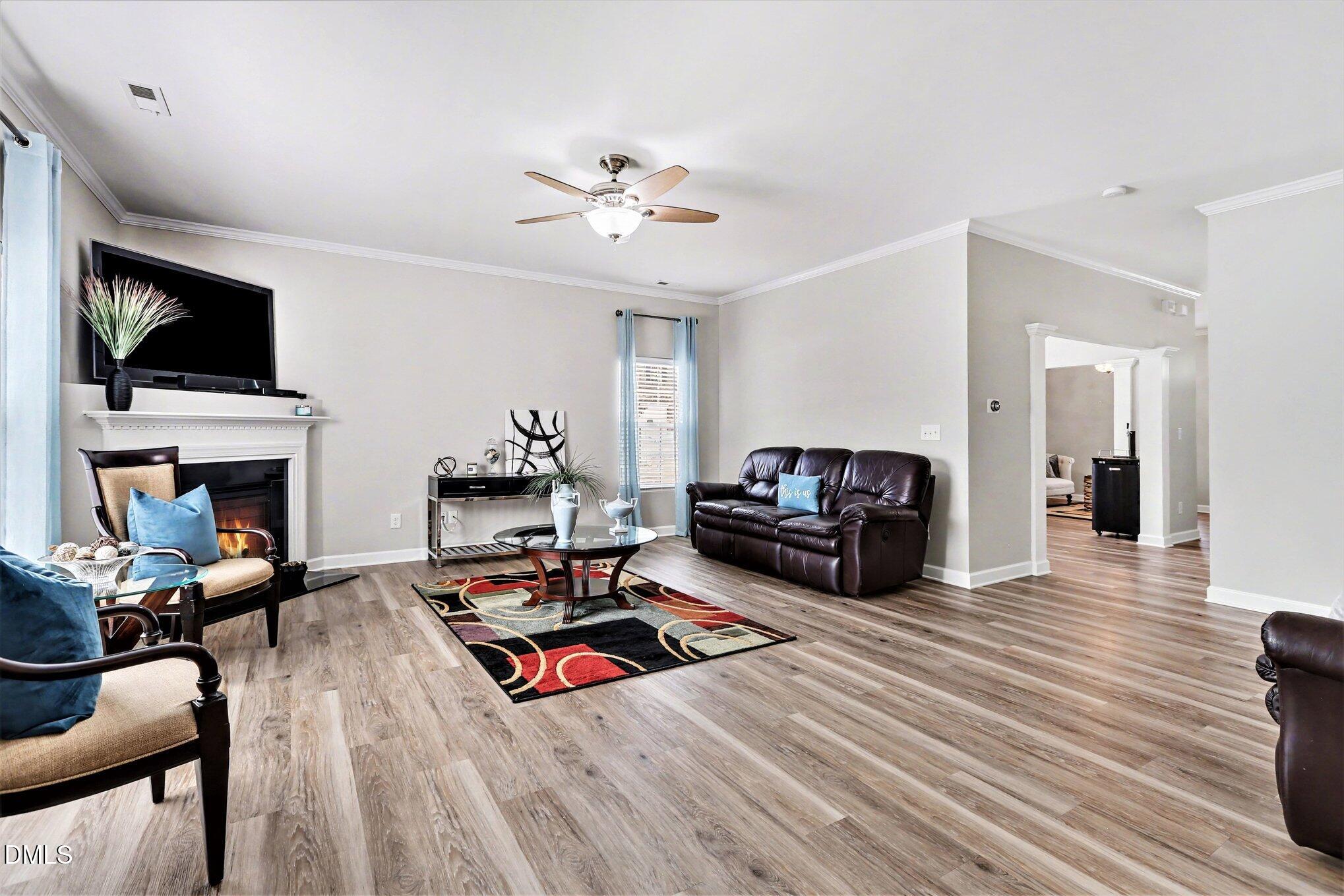 437 Field Glow Lane Apex, NC 27539 - Photo 12 of 48 a living room with furniture fireplace and flat screen tv
