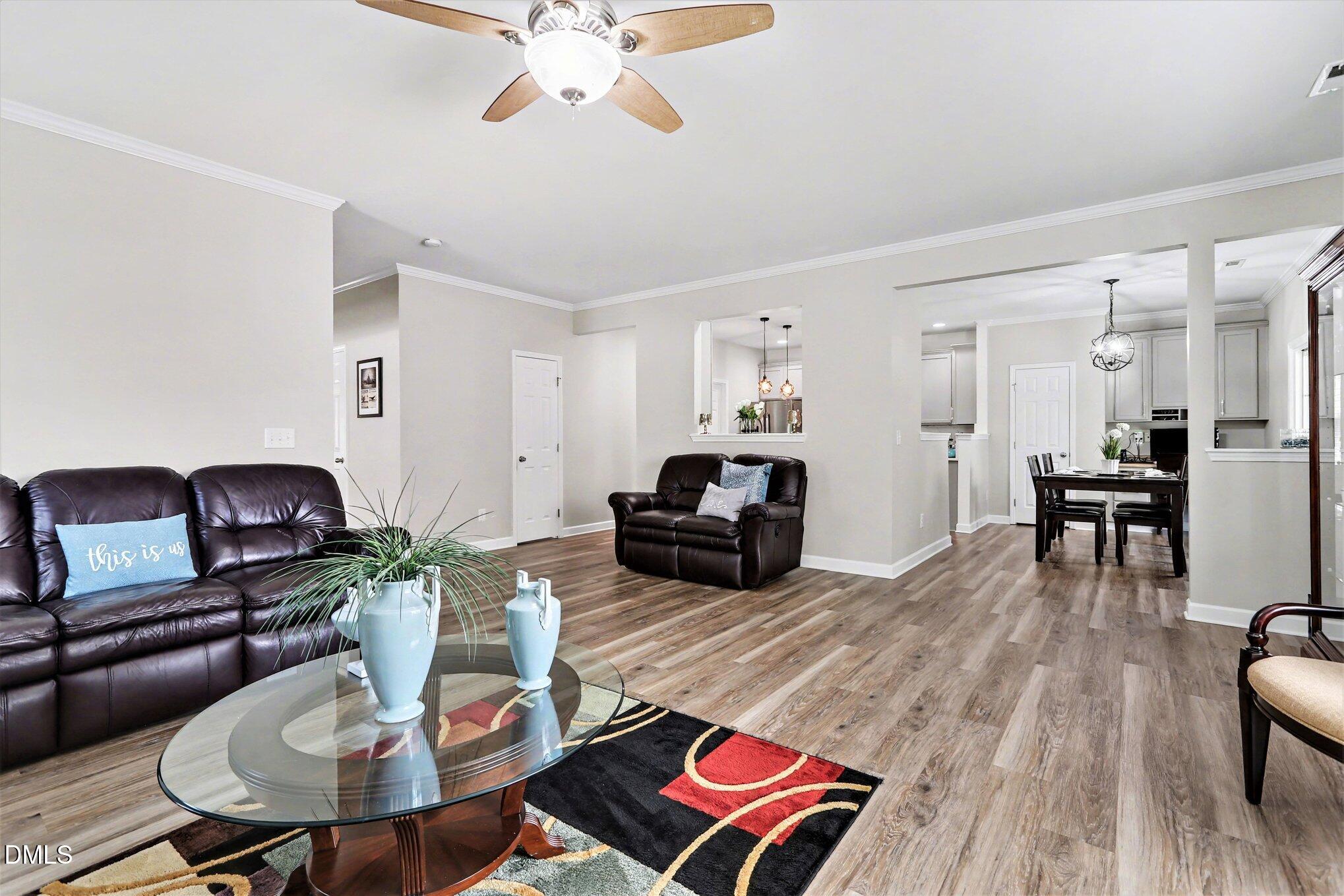437 Field Glow Lane Apex, NC 27539 - Photo 13 of 48 a living room with furniture kitchen view and a table