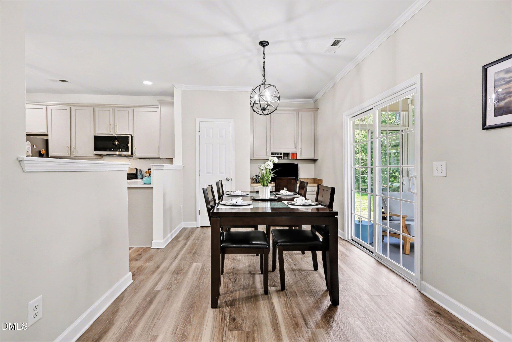 437 Field Glow Lane Apex, NC 27539 - Photo 14 of 48 a view of a dining room with furniture window and wooden floor