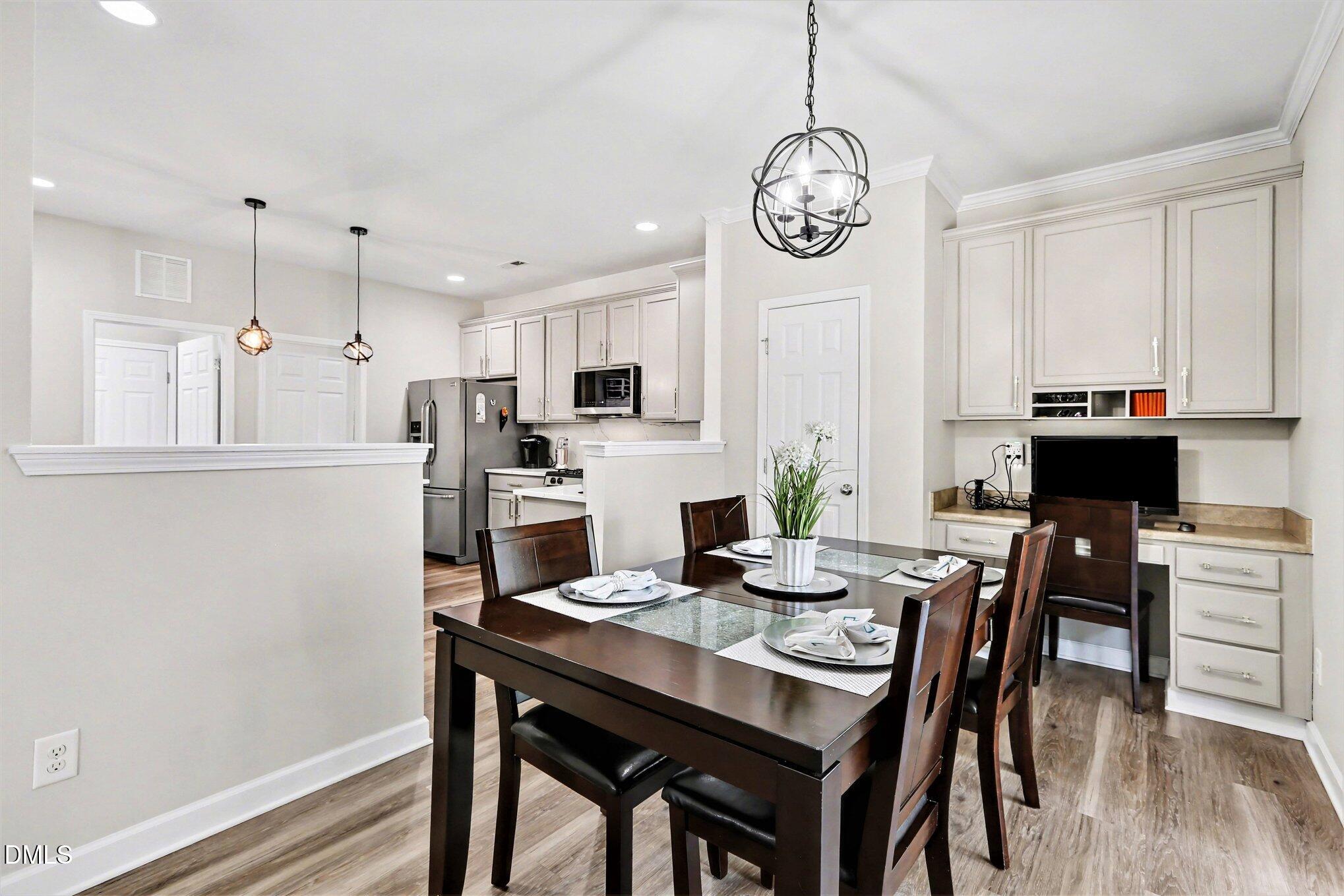 437 Field Glow Lane Apex, NC 27539 - Photo 15 of 48 a view of a dining room with furniture window and wooden floor