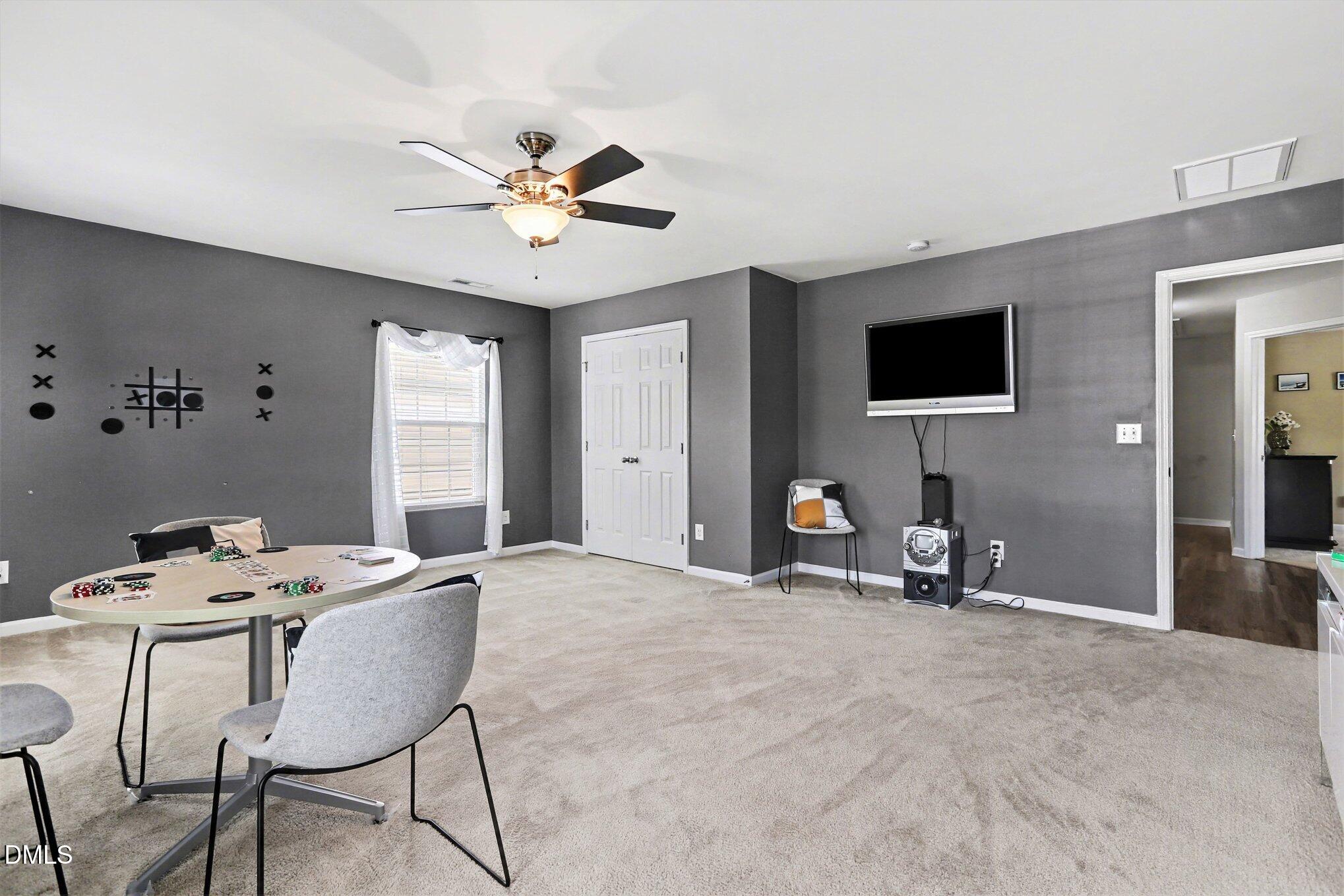 437 Field Glow Lane Apex, NC 27539 - Photo 21 of 48 a view of a livingroom with furniture and a ceiling fan