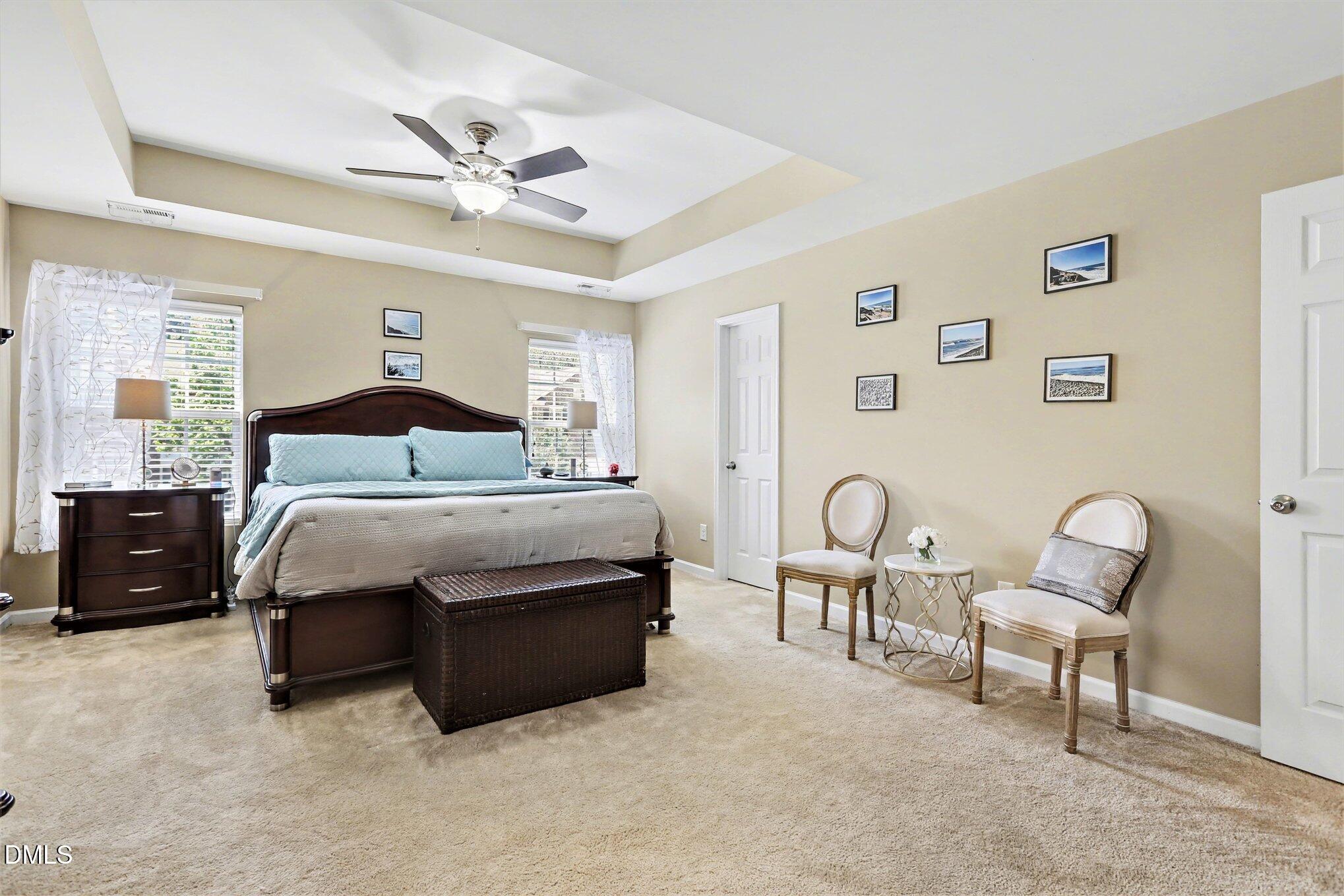 437 Field Glow Lane Apex, NC 27539 - Photo 22 of 48 a bedroom with a bed and a chair