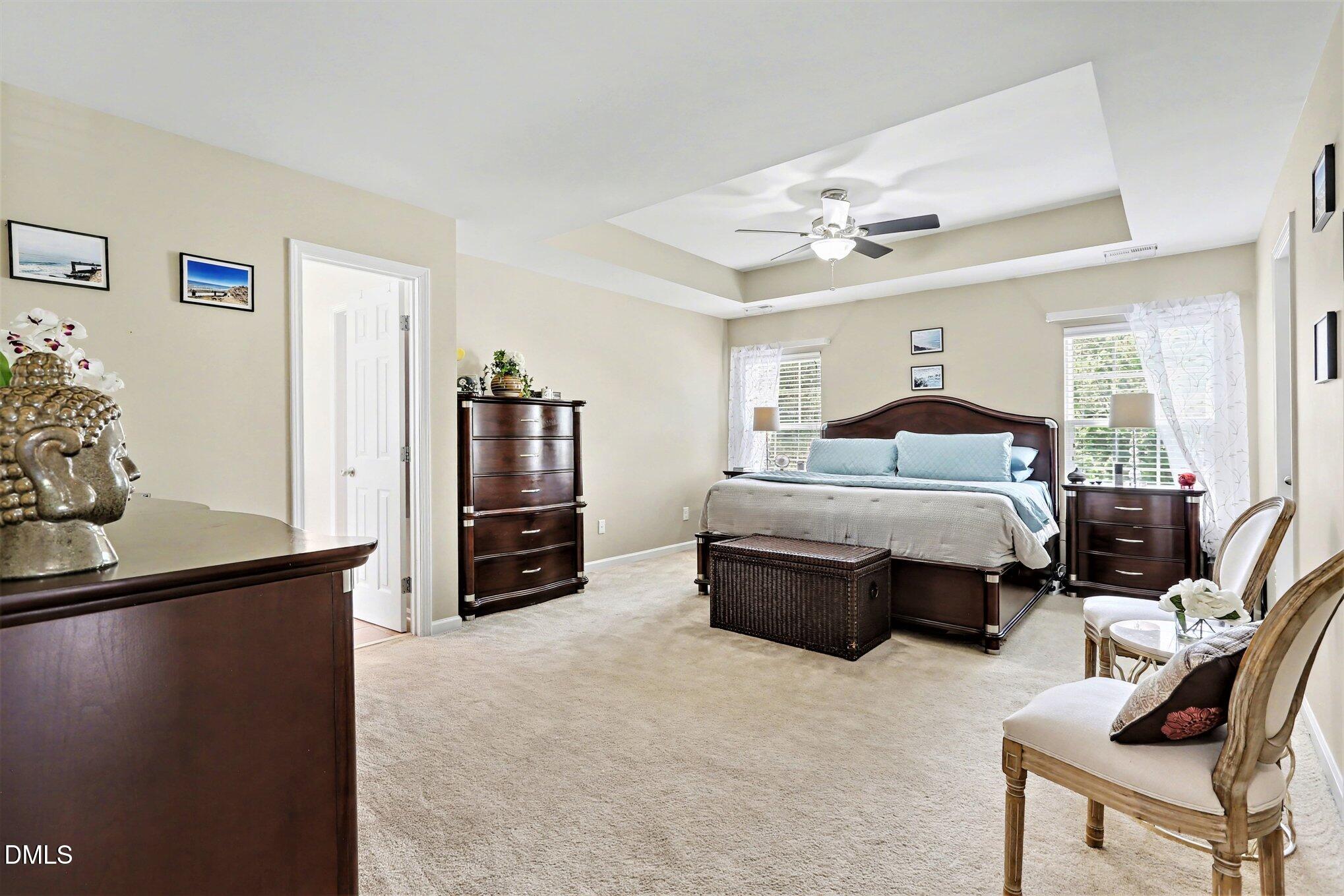 437 Field Glow Lane Apex, NC 27539 - Photo 23 of 48 a bedroom with furniture and a flat screen tv