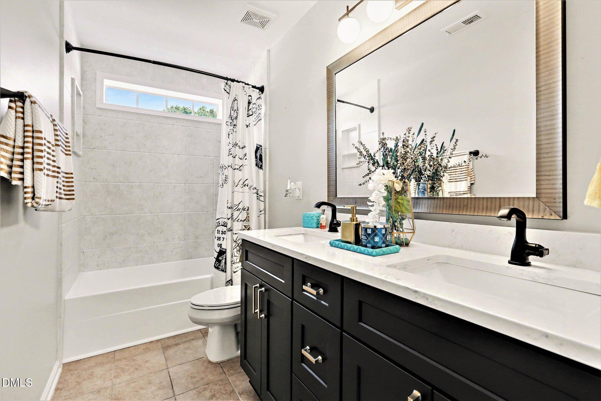437 Field Glow Lane Apex, NC 27539 - Photo 25 of 48 a bathroom with a sink a toilet and a bathtub