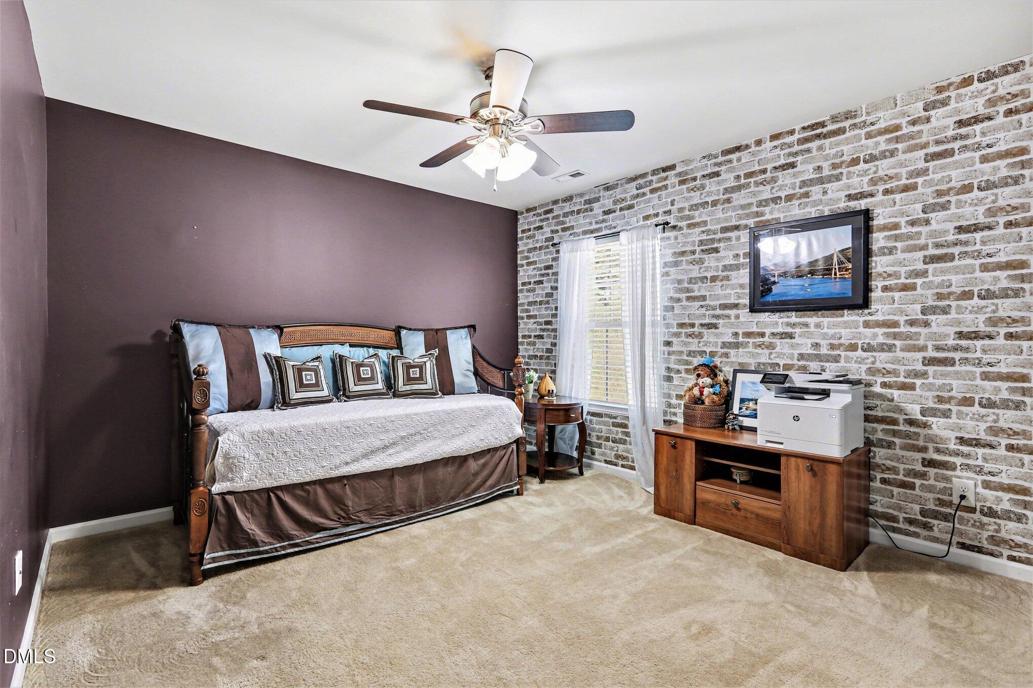 437 Field Glow Lane Apex, NC 27539 - Photo 28 of 48 a spacious bedroom with a bed and a flat screen tv