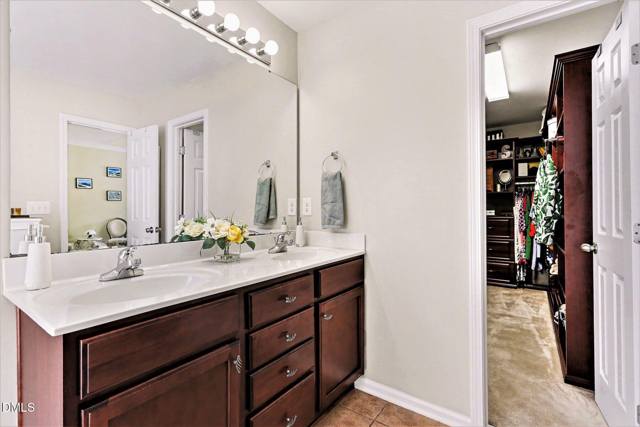 437 Field Glow Lane Apex, NC 27539 - Photo 30 of 48 a bathroom with a sink double vanity and a mirror