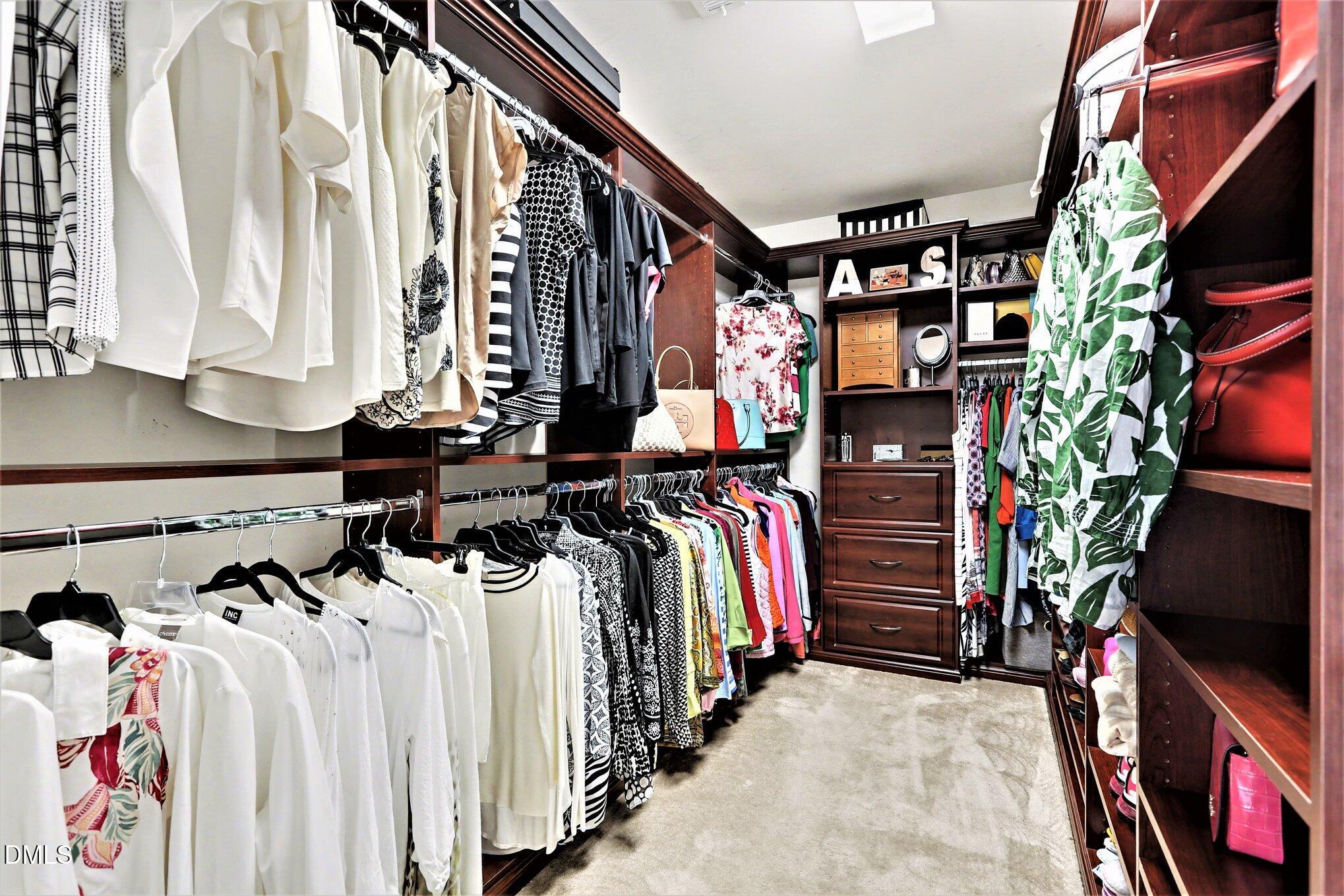 437 Field Glow Lane Apex, NC 27539 - Photo 33 of 48 a view of walk in closet with clothes