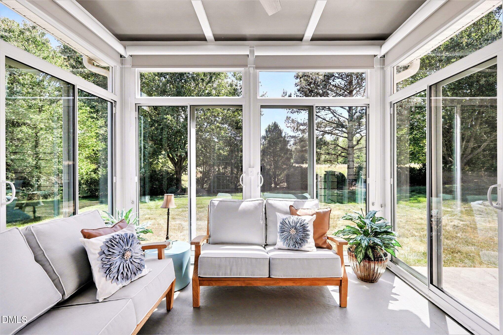 437 Field Glow Lane Apex, NC 27539 - Photo 35 of 48 a living room with furniture and floor to ceiling windows