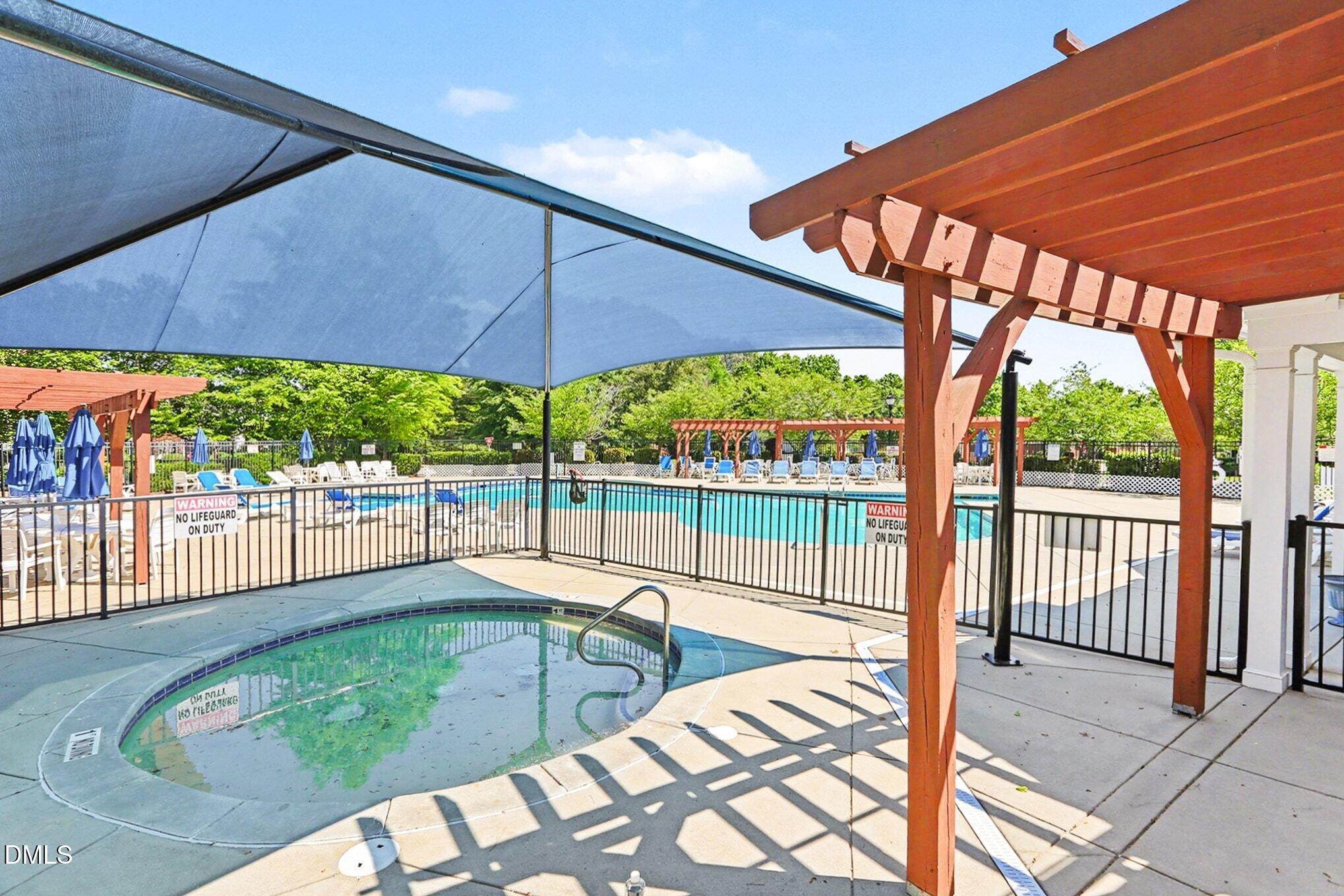 437 Field Glow Lane Apex, NC 27539 - Photo 40 of 48 a view of a patio with a table and chairs under an umbrella