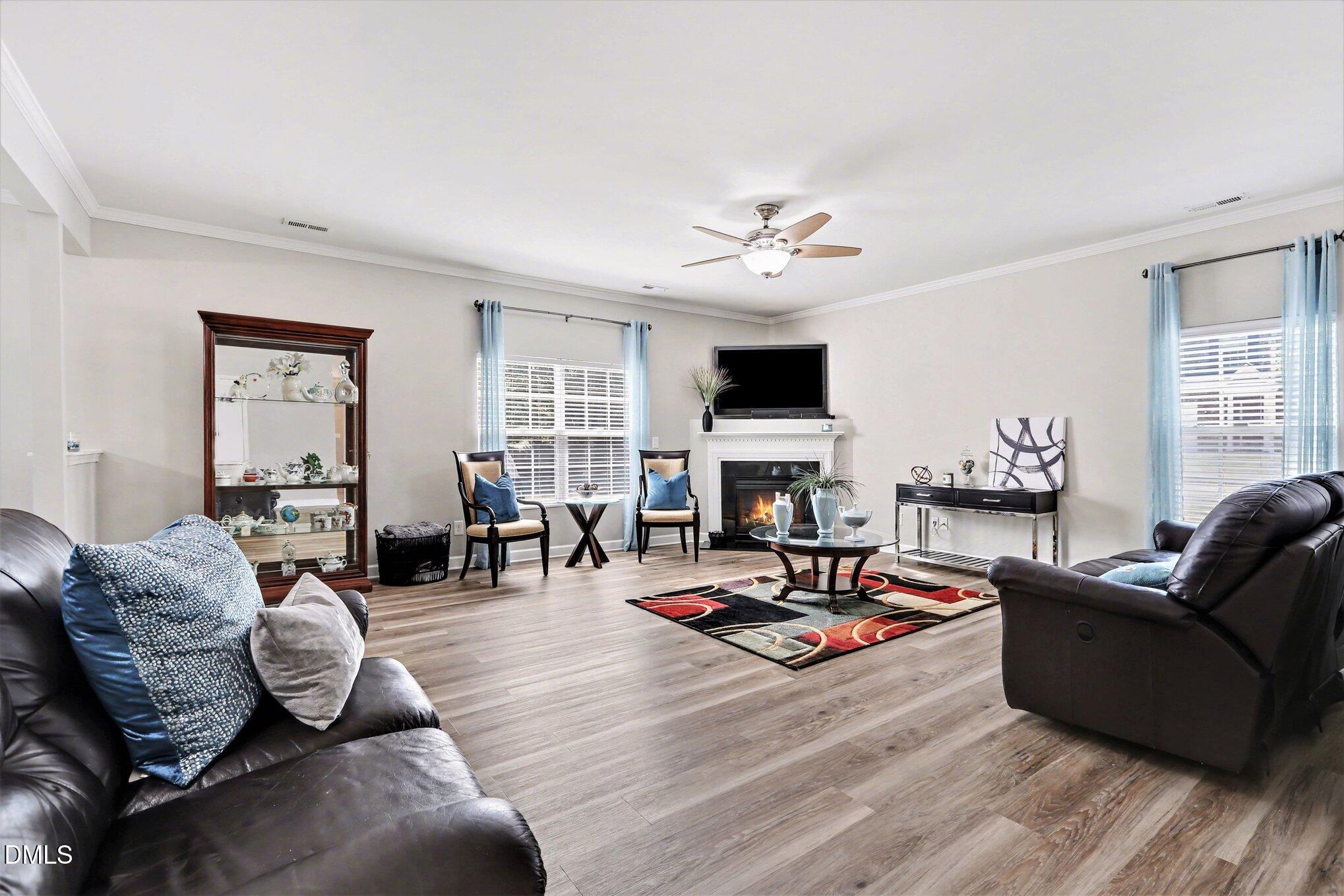 437 Field Glow Lane Apex, NC 27539 - Photo 9 of 48 a living room with furniture fireplace and a window