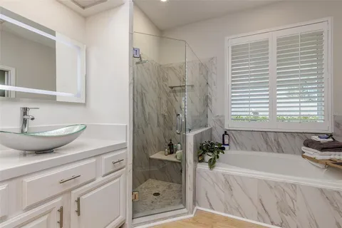 a bathroom with a tub and a window