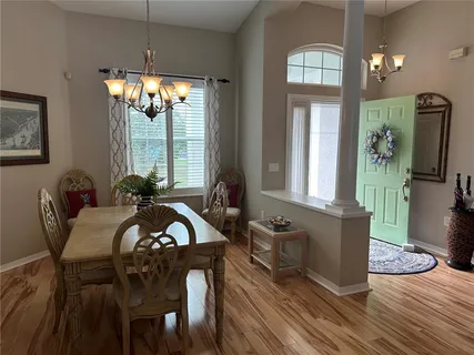 a view of a dining room with furniture and chandelier