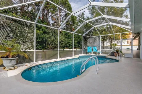 a view of a swimming pool with outdoor seating and yard