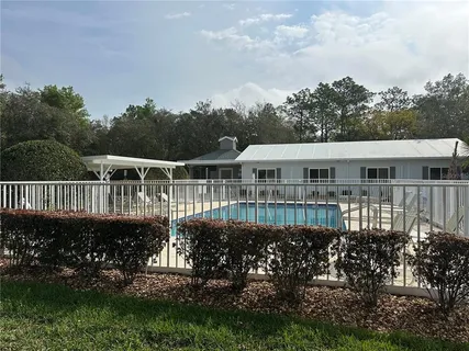 a view of a brick house with potted plants