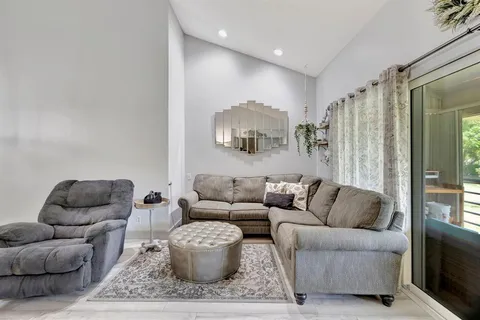 a living room with furniture and a rug