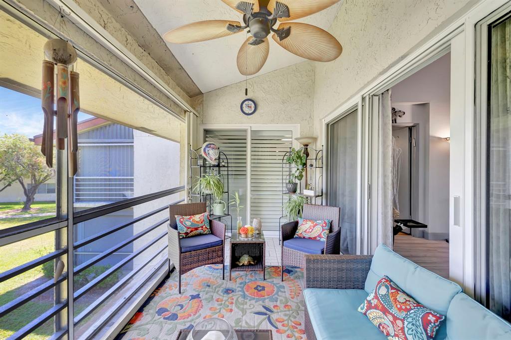 8799 Holly Court, Unit 202 Tamarac, FL 33321 - Photo 17 of 26 a bedroom with furniture and a large window