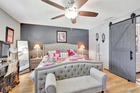 a bedroom with furniture and a dresser
