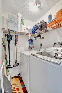 a room with gym equipment and wooden floor