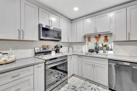 a kitchen with cabinets appliances cabinets and a counter top space