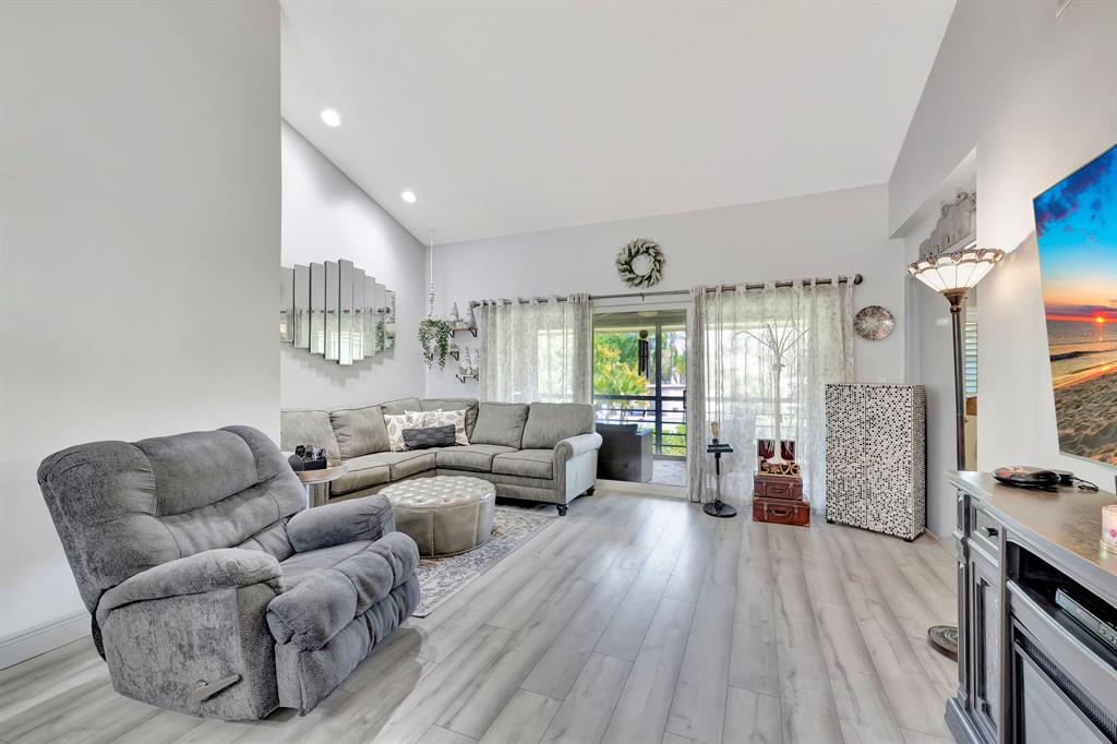 8799 Holly Court, Unit 202 Tamarac, FL 33321 - Photo 9 of 26 a living room with furniture and a large window