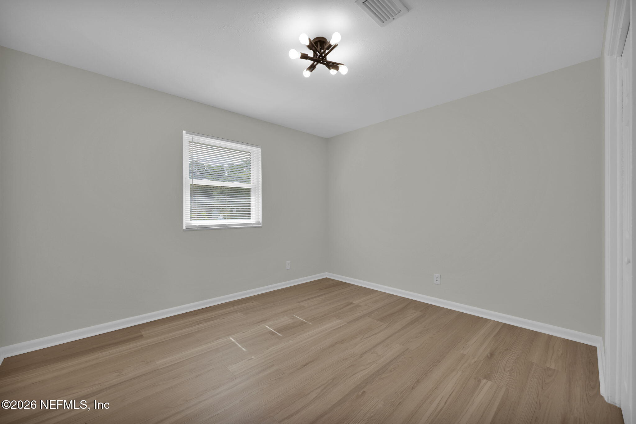 8544 Sanchez Road Jacksonville, FL 32217 - Photo 29 of 46 a view of a room with wooden floor and a ceiling fan