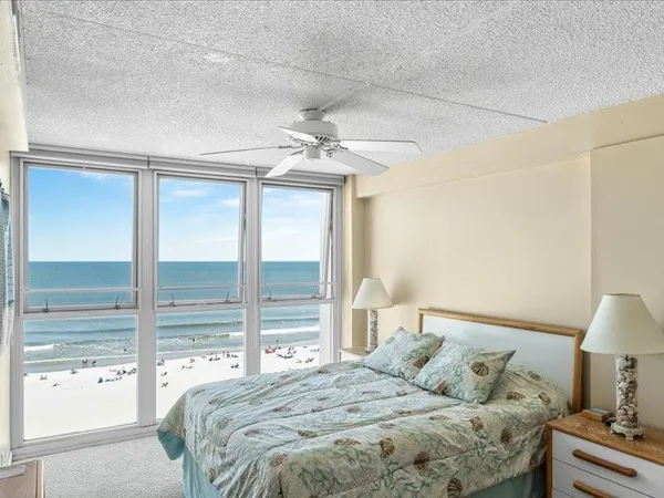 a view of a room that has a bed and a window