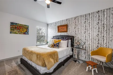 a bedroom with a bed and chair