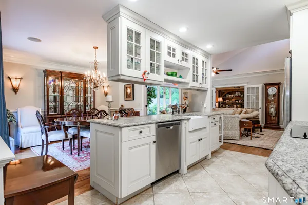 a kitchen with cabinets and chairs in it