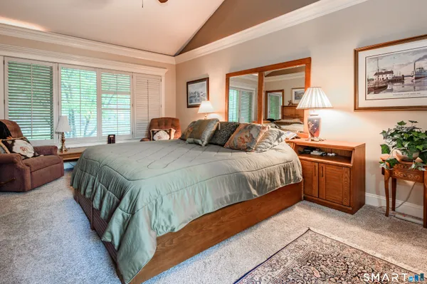 a bedroom with a bed and a couch