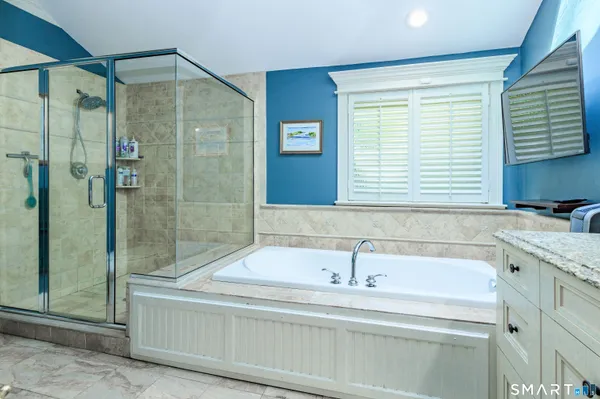 a bathroom with a bathtub and a shower