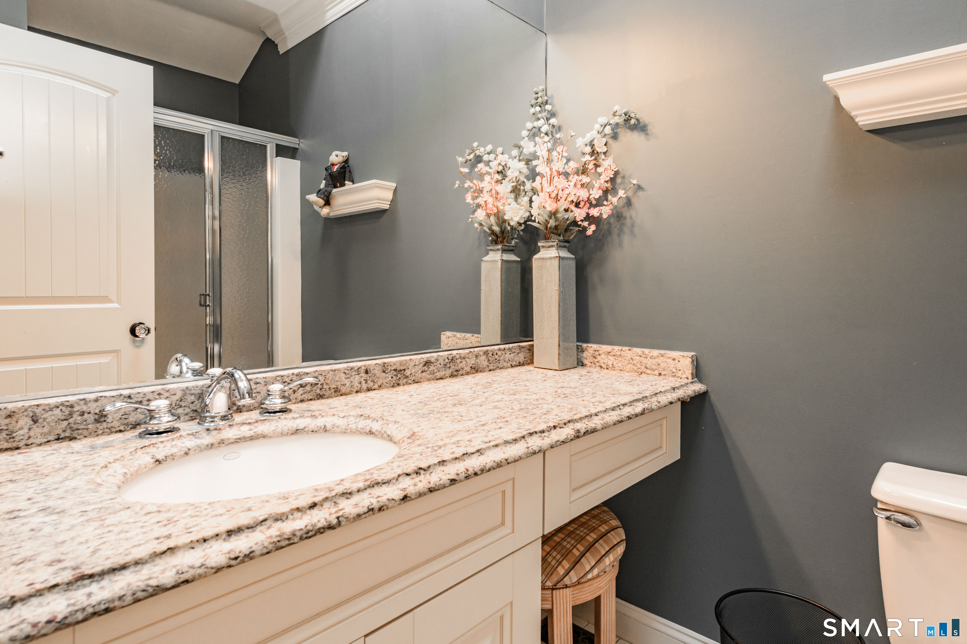 2 Bramble Bush, Unit 2 Avon, CT 06001 - Photo 25 of 40 a bathroom with a granite countertop sink a toilet and a mirror