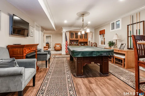 a dining room with furniture and wooden floor