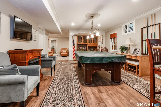 a dining room with furniture and wooden floor