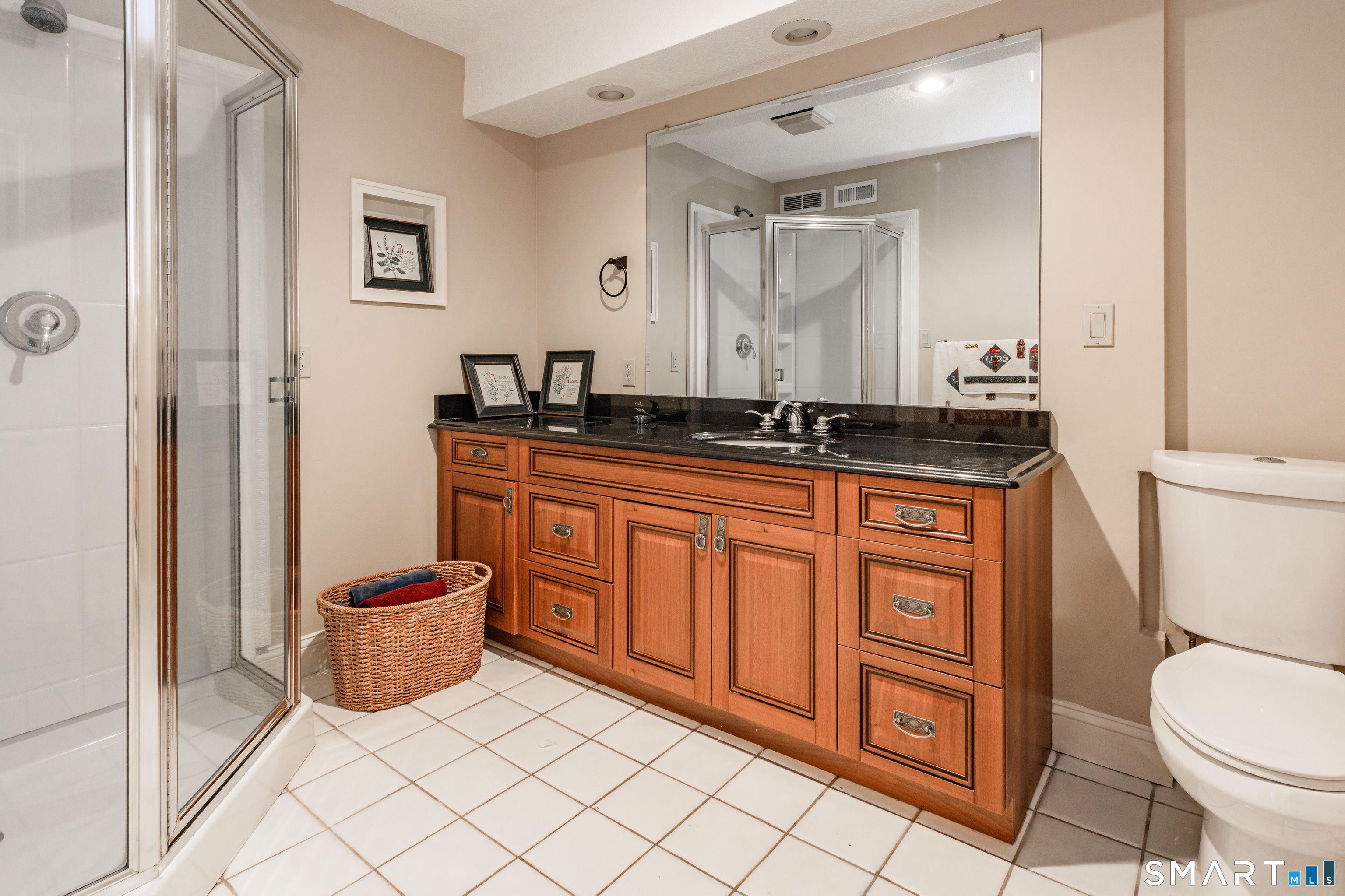 2 Bramble Bush, Unit 2 Avon, CT 06001 - Photo 30 of 40 a spacious bathroom with a granite countertop toilet sink and mirror