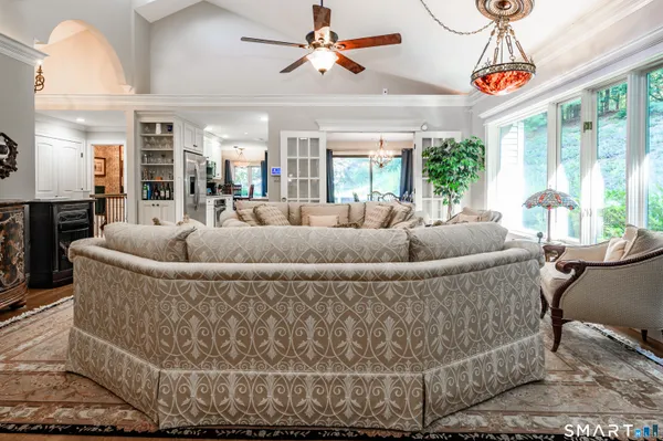 a living room with furniture and a chandelier