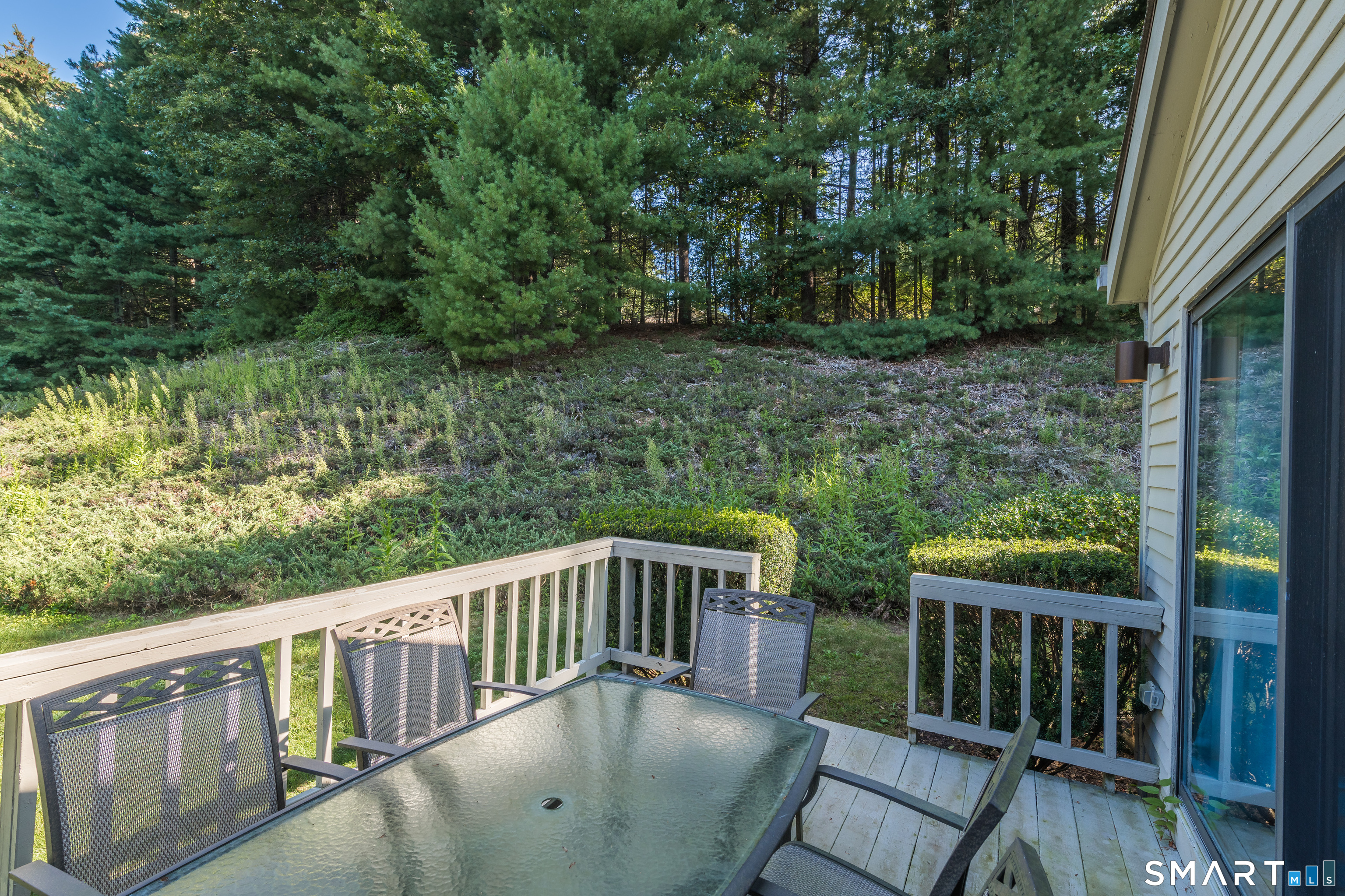 2 Bramble Bush, Unit 2 Avon, CT 06001 - Photo 35 of 40 a balcony with wooden floor and yard in back