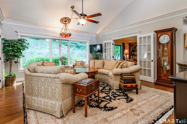 a living room with furniture a chandelier and a window
