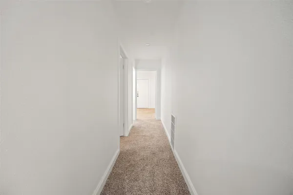 a view of a hallway with white walls